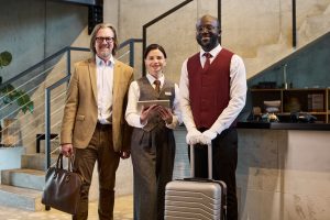 Business Colleagues Standing in Hotel Lobby with Luggage